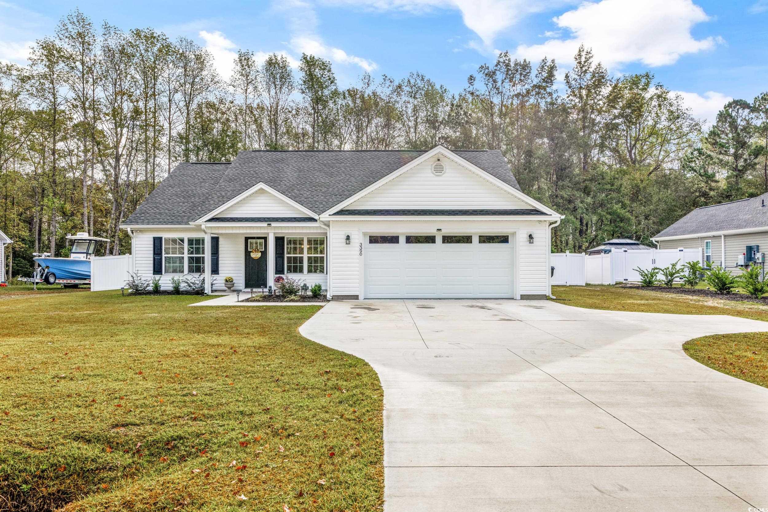 3390 Dusty Road Loris, SC 29569 - Photo 1 of 33 View of front facade with a front yard and a garag