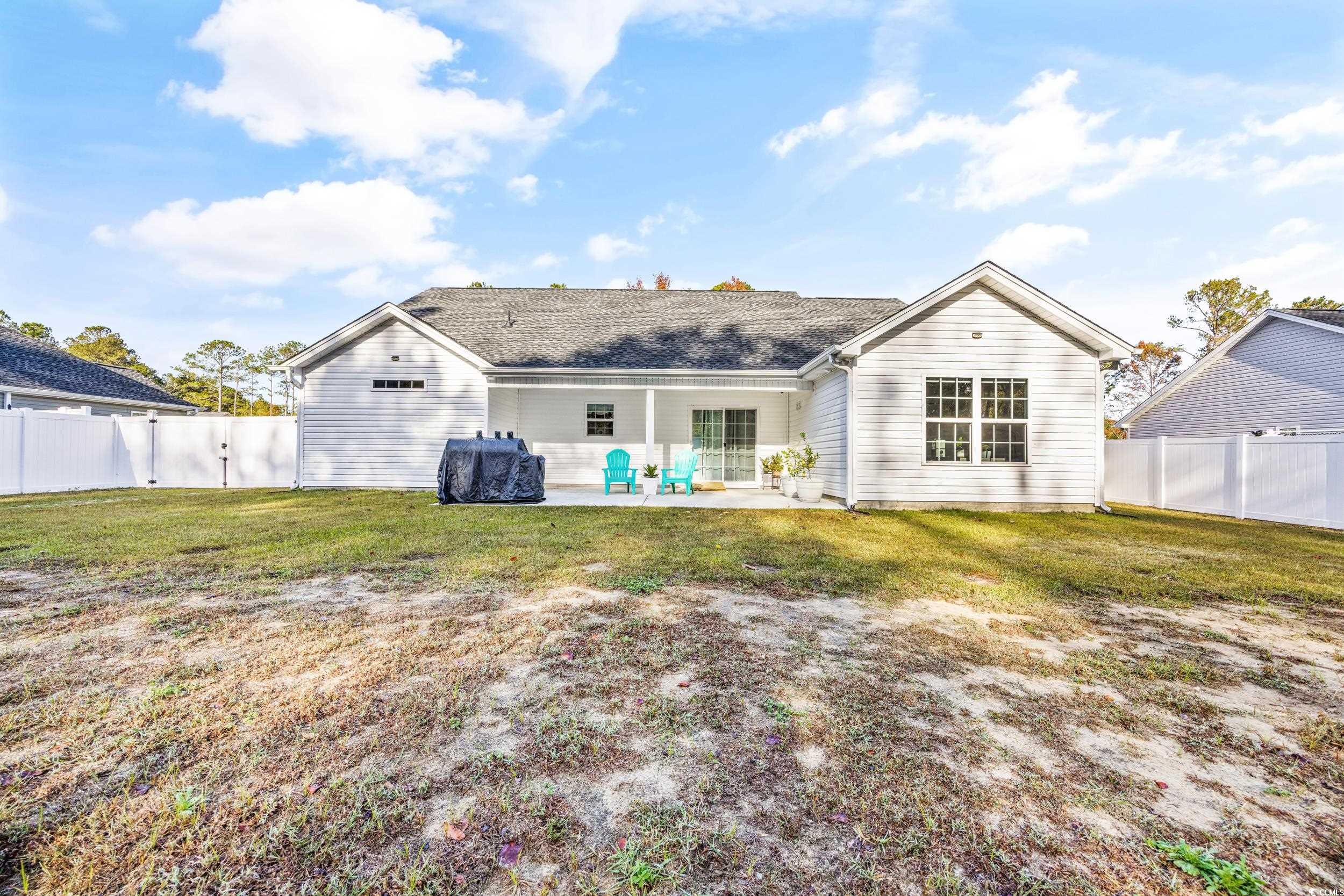 3390 Dusty Road Loris, SC 29569 - Photo 25 of 33 Back of property with a patio area and a lawn