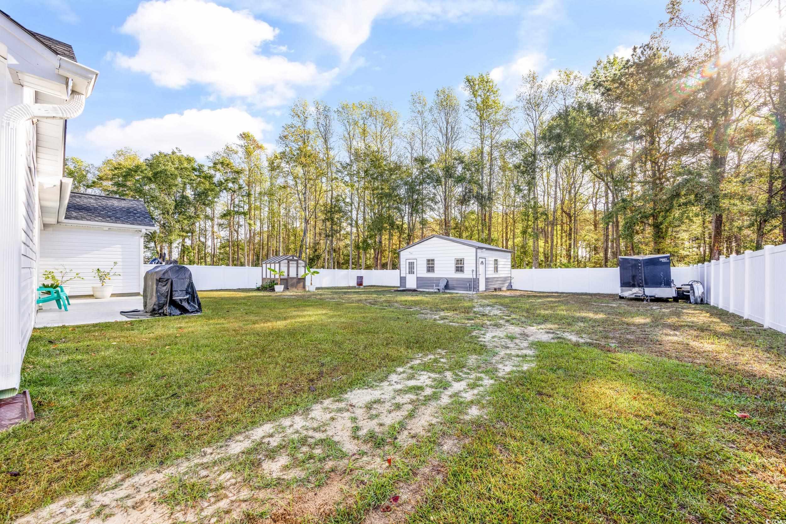 3390 Dusty Road Loris, SC 29569 - Photo 27 of 33 View of yard with a patio area and a storage unit