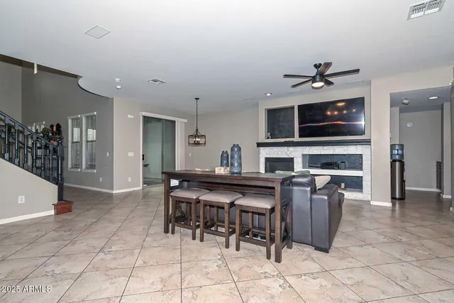 a bedroom with a bed a table and painting on the wall