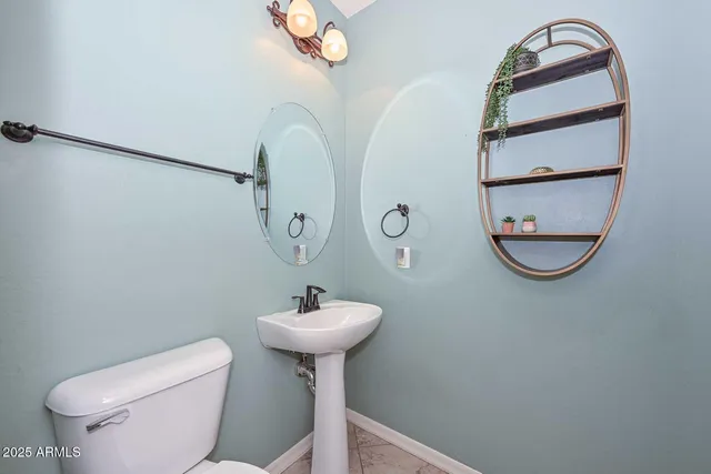 a bedroom with a bed and a chandelier fan