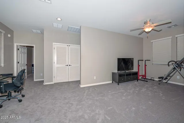 a view of a porch with a table and chairs under an umbrella