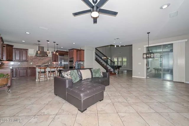 a view of a house with backyard and sitting area