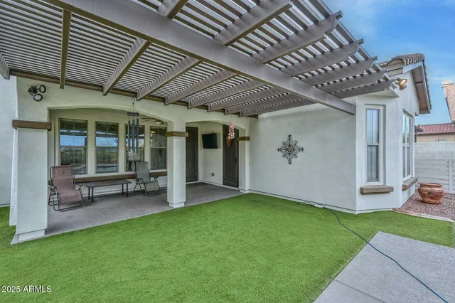 a view of a patio with couches table and chairs and potted plants