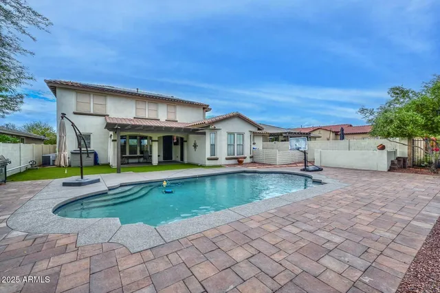 a kitchen with granite countertop cabinets and chairs