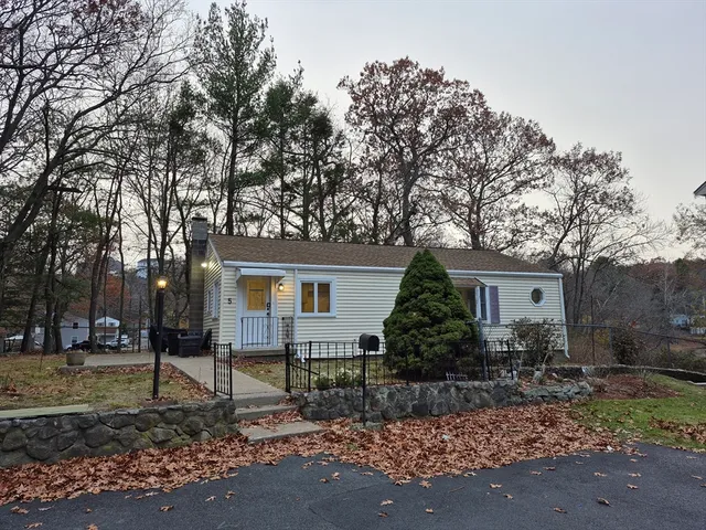a house that has a tree in front of the house