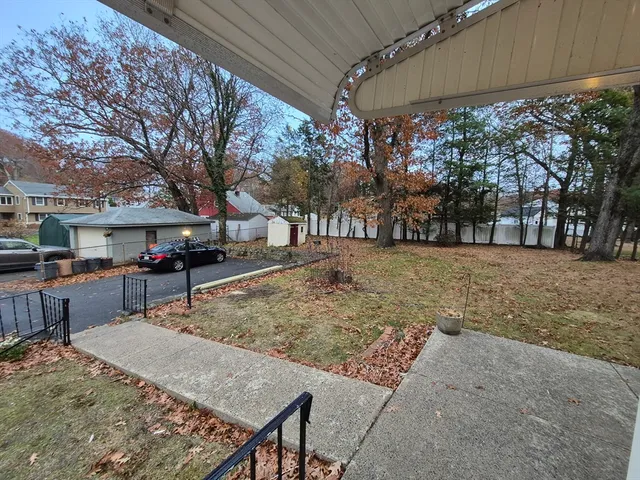 a view of a backyard with large trees