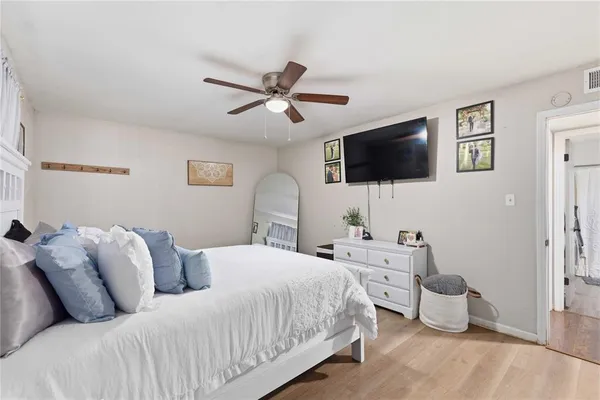 a bedroom with a bed and a flat screen tv