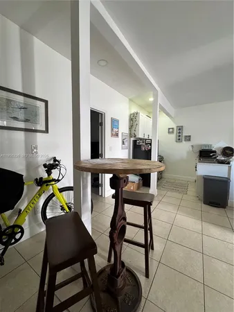 a view of a dining room with furniture and a kitchen