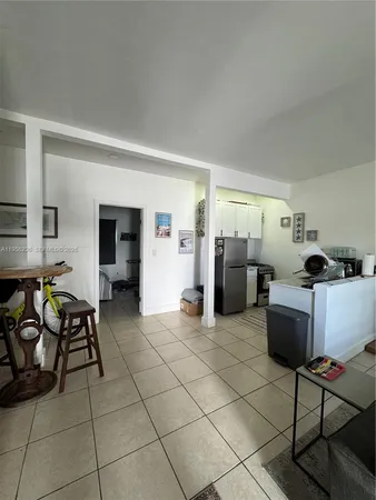 a living room with furniture a dining table and chairs