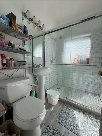 a bathroom with a toilet and a shower