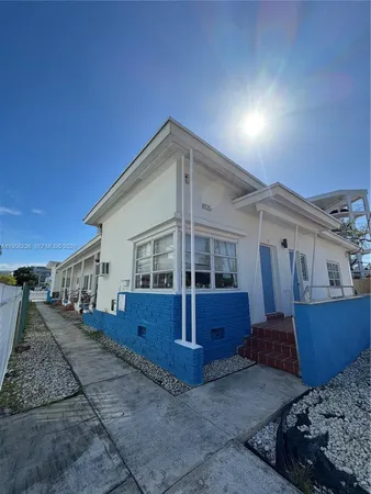 a view of a house with wooden fence