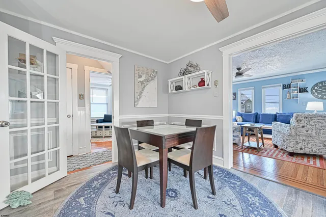a view of a dining room with furniture and wooden floor