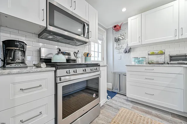 a kitchen with granite countertop stainless steel appliances and cabinets
