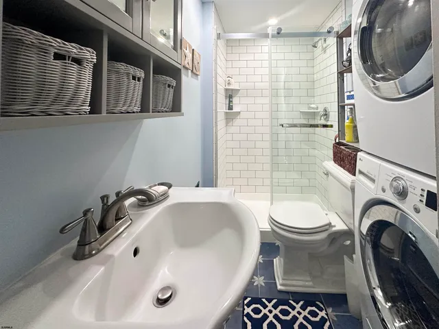 a bathroom with a sink a toilet and a shower