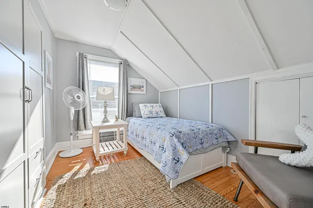 a bedroom with a bed next to a large window with the outer view