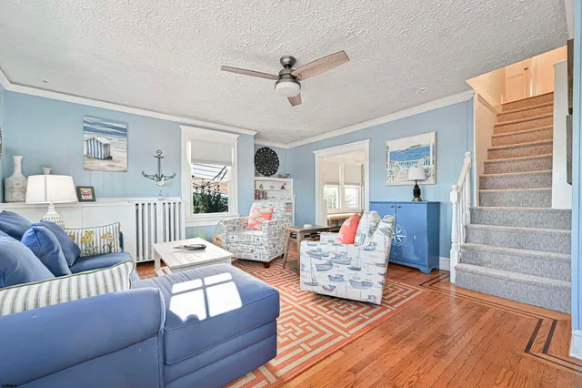 a living room with furniture and a wooden floor