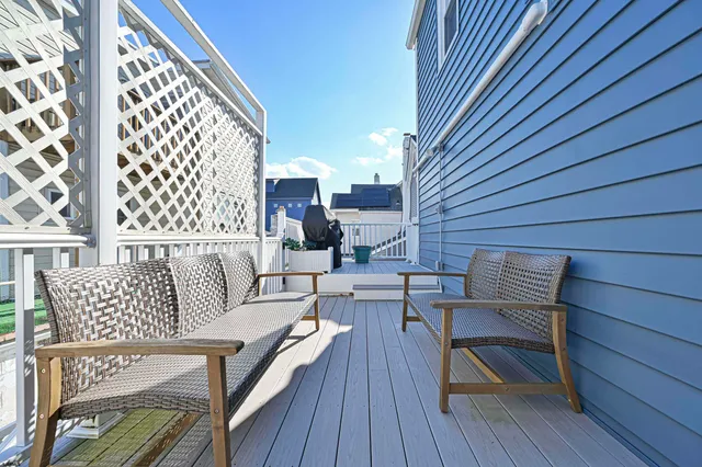a outdoor living room with furniture and wooden floor