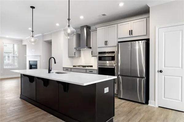 a kitchen with stainless steel appliances a sink stove and refrigerator