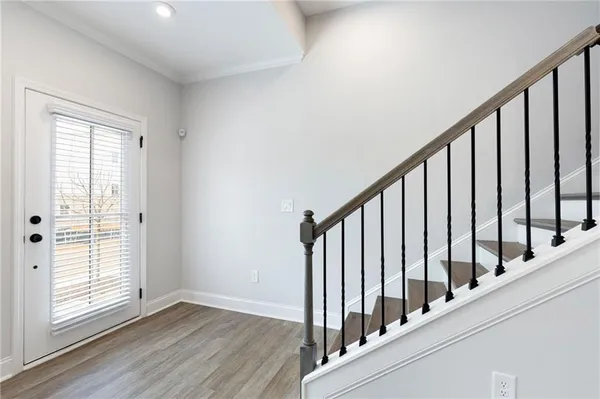 a view of an entryway with wooden floor