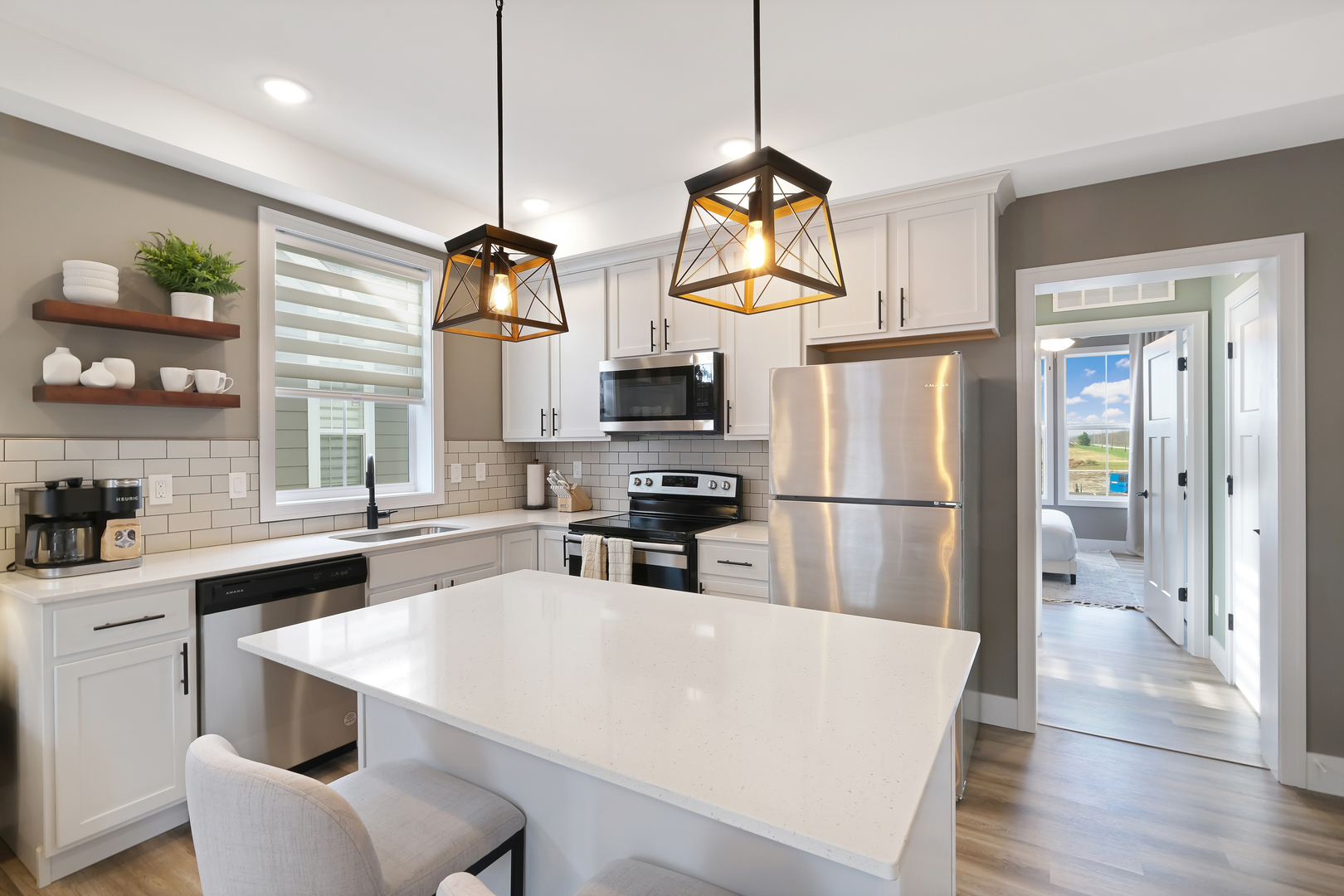 214 Great Lp Drive, Unit 2A Ottawa, IL 61350 - Photo 6 of 10 a kitchen with stainless steel appliances a stove a refrigerator a sink dishwasher a oven a dining table and chairs with wooden floor