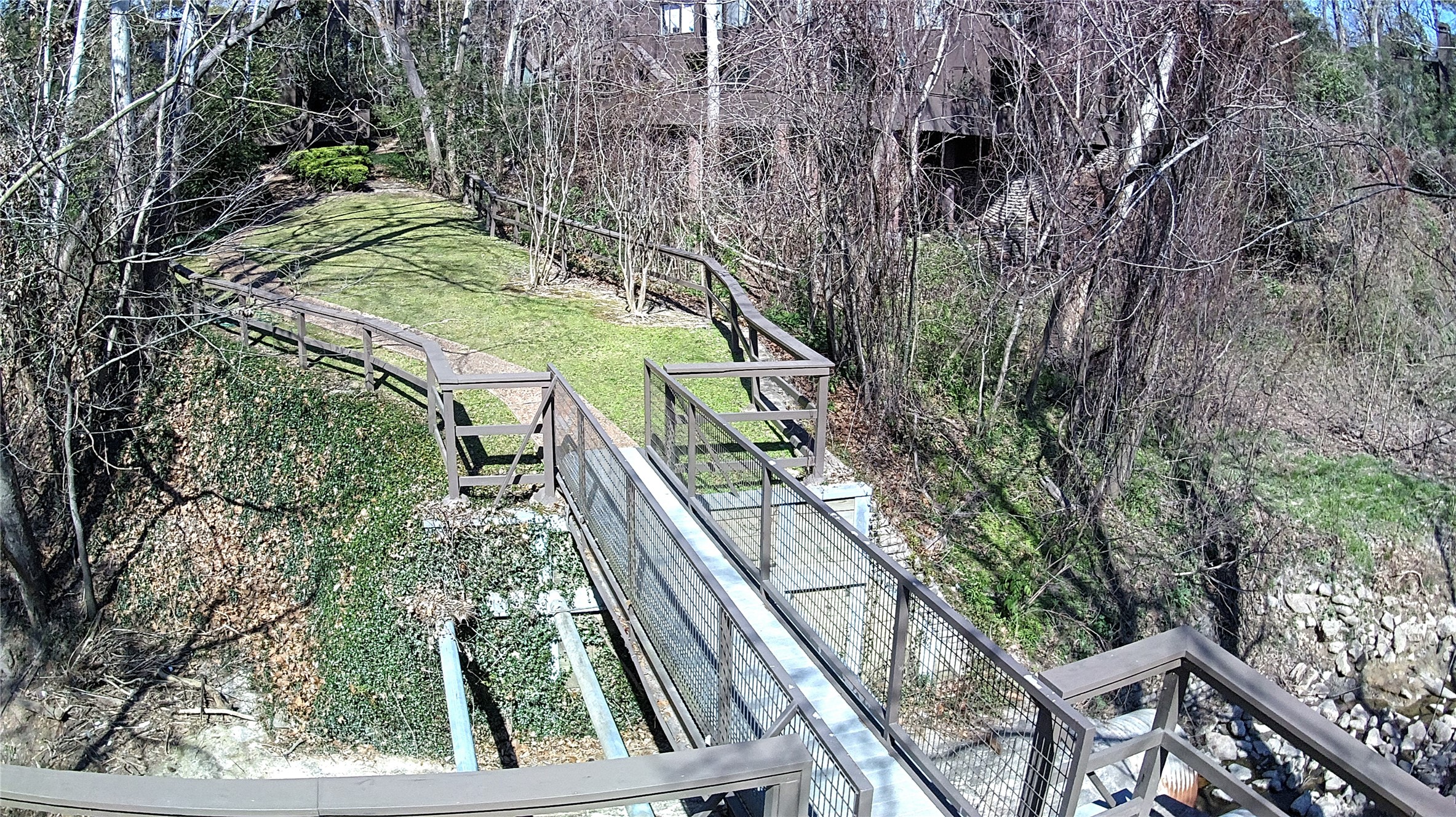 238 Litchfield Lane Houston, TX 77024 - Photo 23 of 25 Charming bridge over the bayou leads directly to a private tennis court.