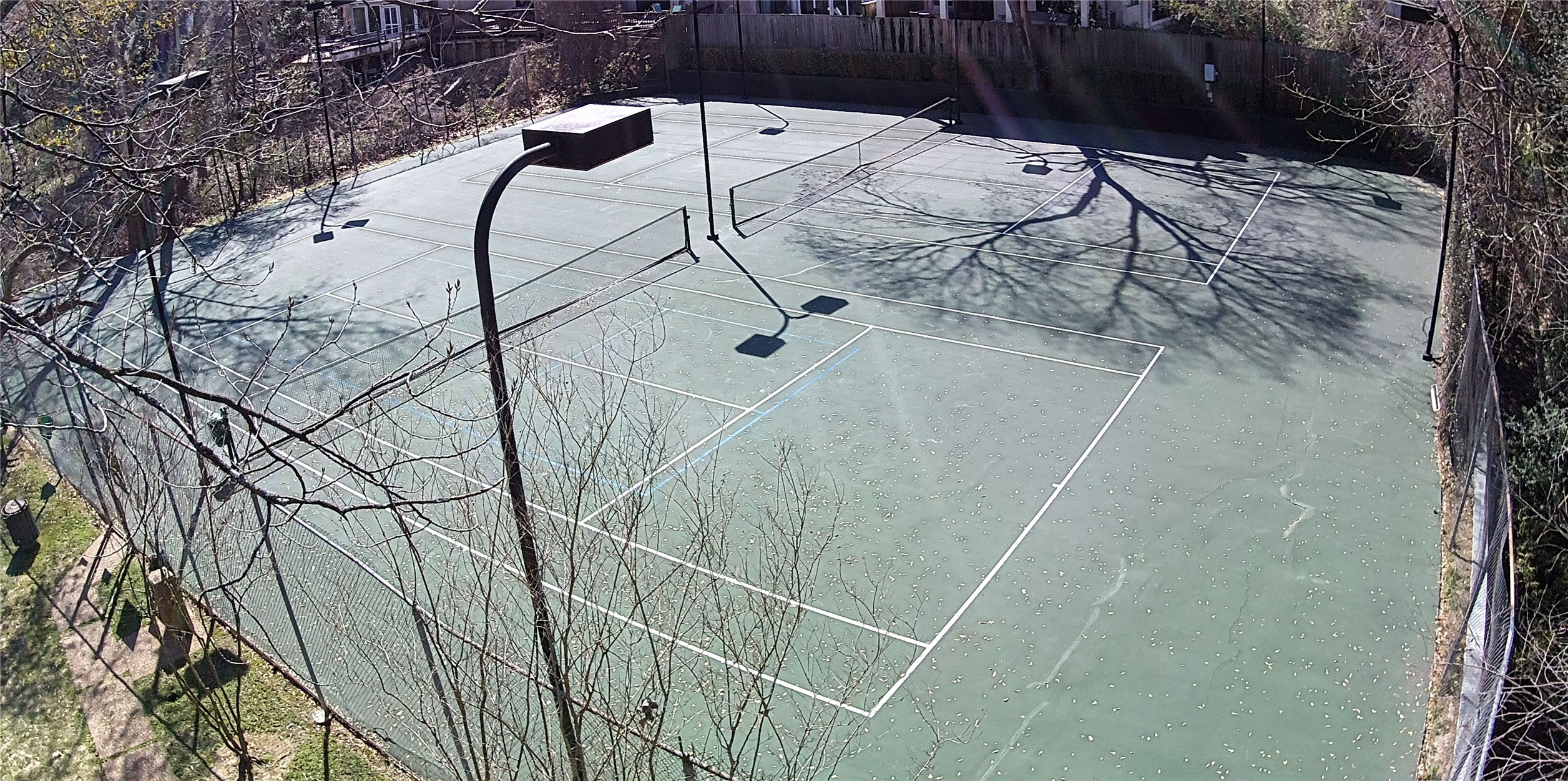 238 Litchfield Lane Houston, TX 77024 - Photo 24 of 25 Enjoy your own private tennis court, perfect for recreation and enhancing your game right at home.