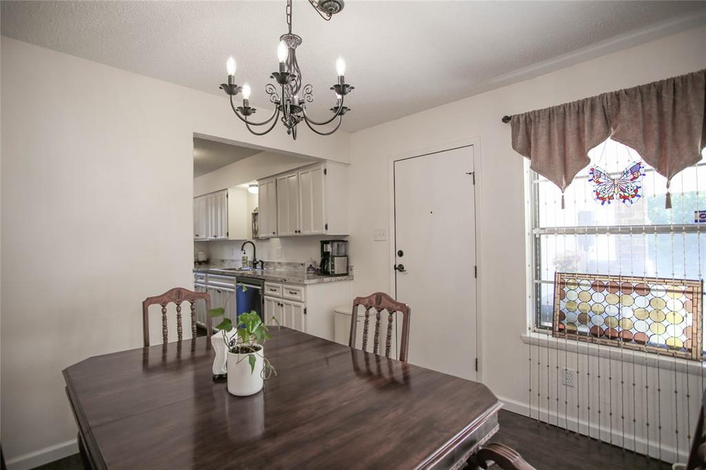 1720 Crystal Way Plano, TX 75074 - Photo 11 of 32 a view of a dining room with furniture a chandelier and wooden floor