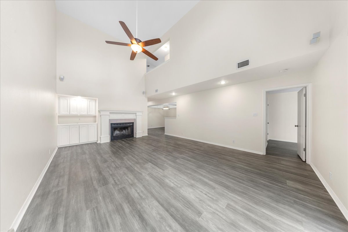 10900 Crown Colony Drive, Unit B Austin, TX 78747 - Photo 11 of 26 wooden floor in an empty room with a window