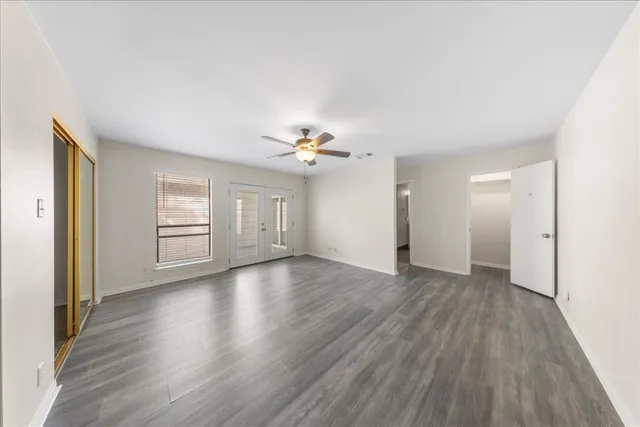 wooden floor in an empty room with a window