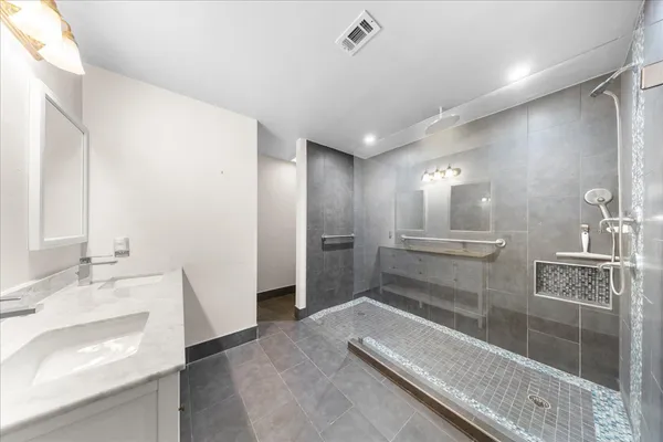 a bathroom with a sink and a large mirror