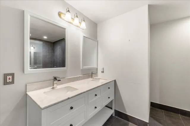a bathroom with a sink vanity and mirror