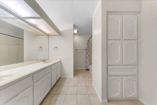 a bathroom with a double vanity sink and mirror