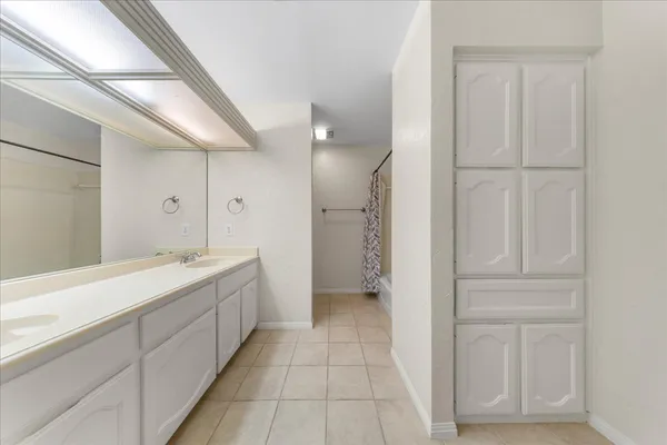 a bathroom with a double vanity sink and mirror