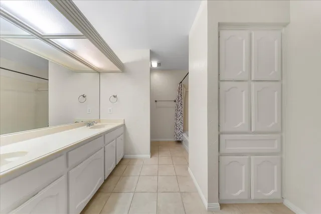 a bathroom with a double vanity sink and mirror