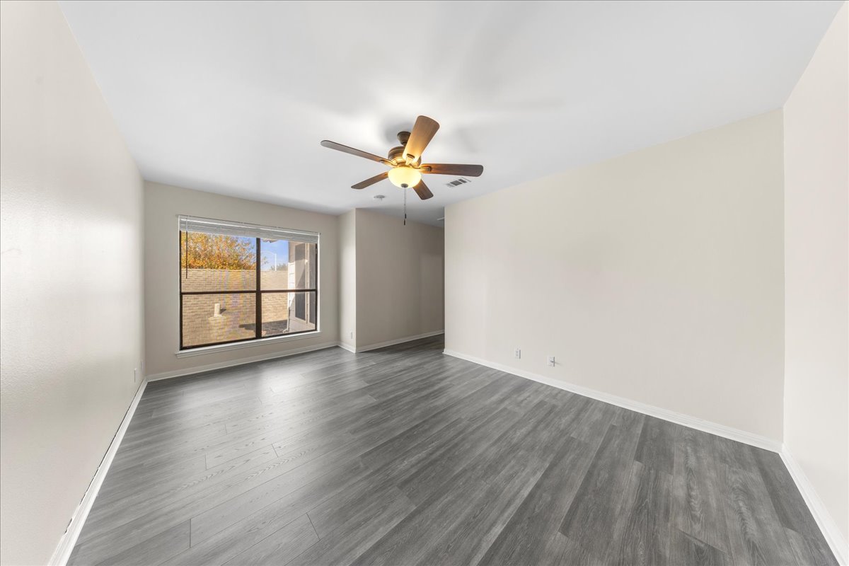 10900 Crown Colony Drive, Unit B Austin, TX 78747 - Photo 24 of 26 wooden floor in an empty room with a window