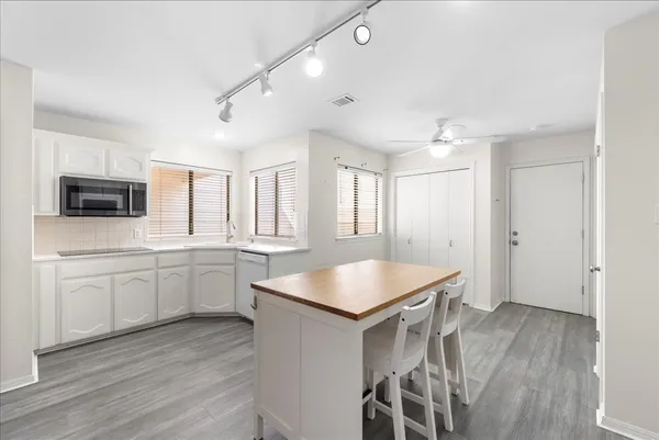 a kitchen with sink cabinets and wooden floor