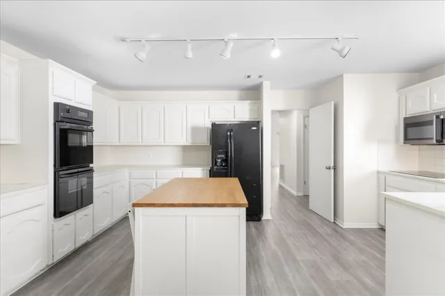 a kitchen with stainless steel appliances a refrigerator sink and microwave