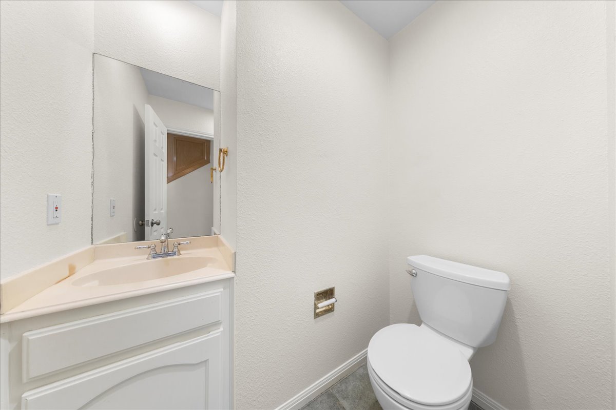 10900 Crown Colony Drive, Unit B Austin, TX 78747 - Photo 7 of 26 a bathroom with a toilet sink and mirror
