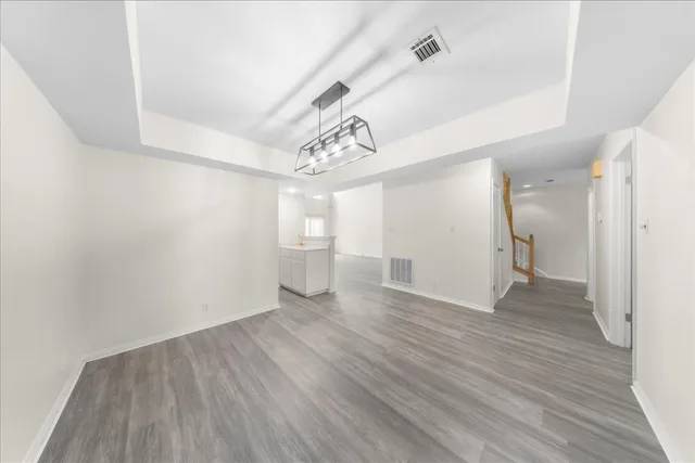 a view of a room with wooden floor and a window