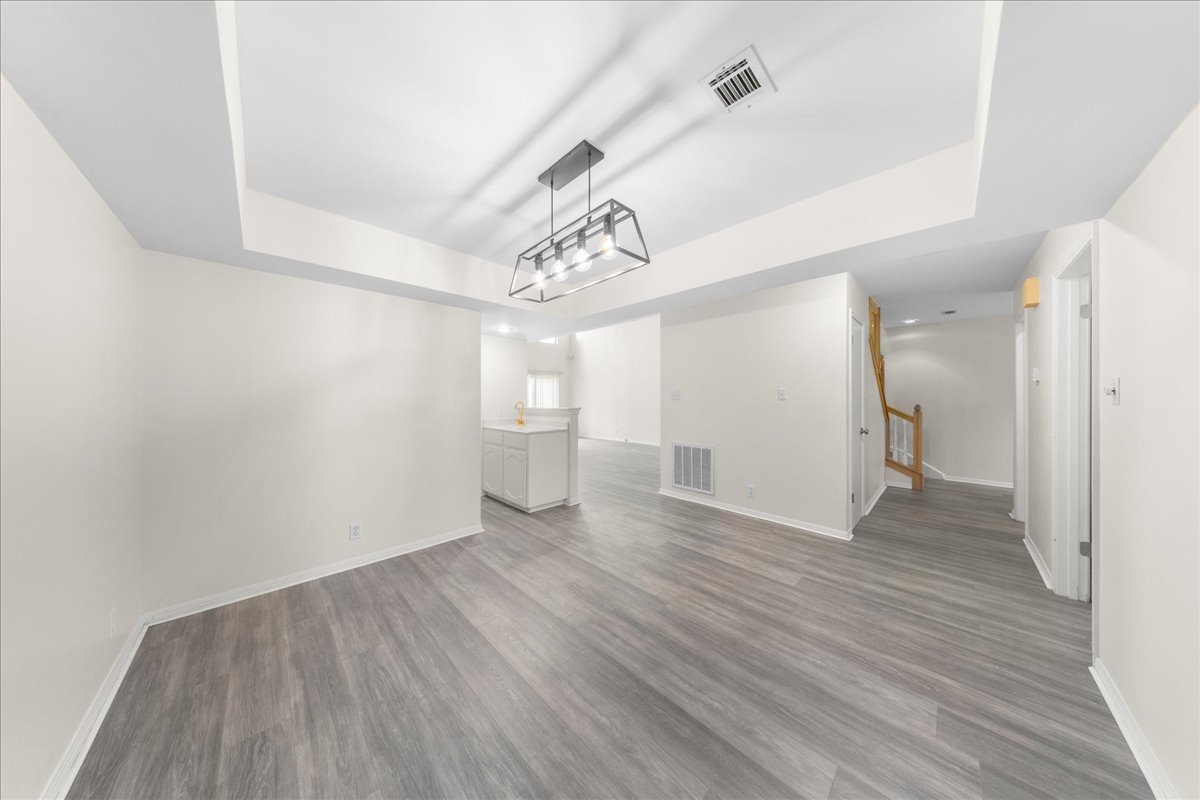 10900 Crown Colony Drive, Unit B Austin, TX 78747 - Photo 8 of 26 a view of a room with wooden floor and a window