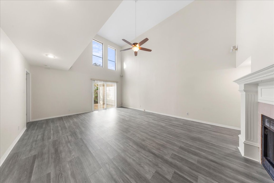 10900 Crown Colony Drive, Unit B Austin, TX 78747 - Photo 10 of 26 wooden floor in an empty room with a window