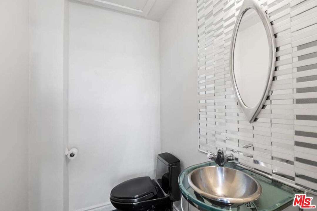 10453 Holman Avenue Los Angeles, CA 90024 - Photo 11 of 67 a bathroom with a sink and a mirror