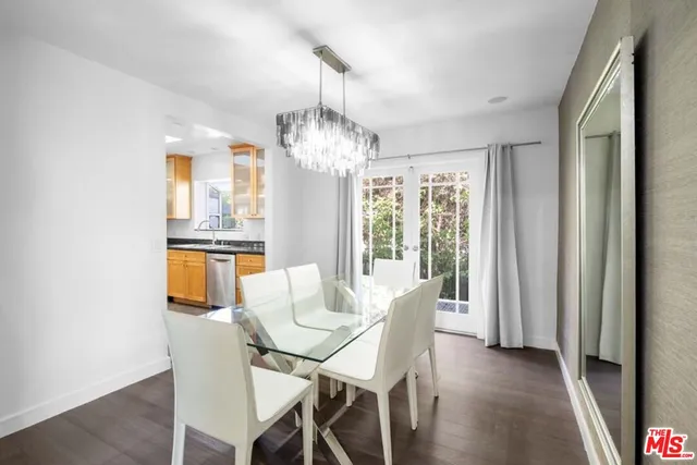 an empty room with wooden floor and stairs