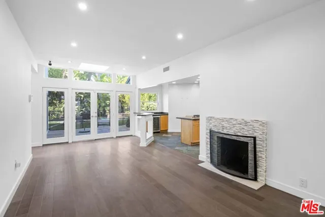 a kitchen with stainless steel appliances granite countertop a refrigerator and a stove