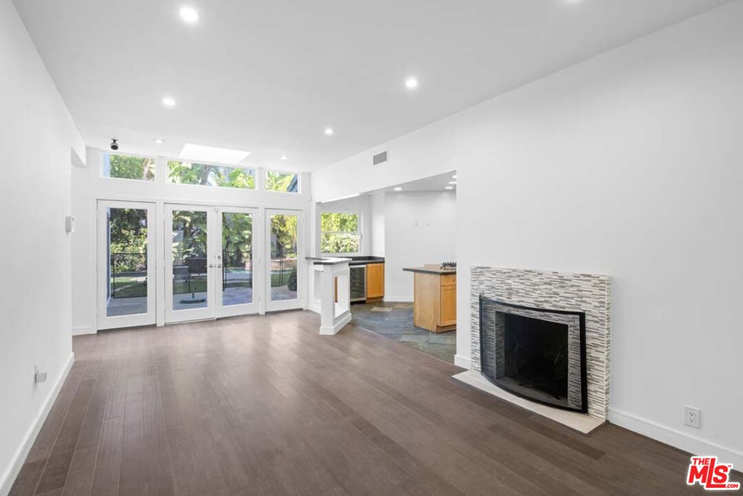 10453 Holman Avenue Los Angeles, CA 90024 - Photo 16 of 67 an empty room with wooden floor and fireplace