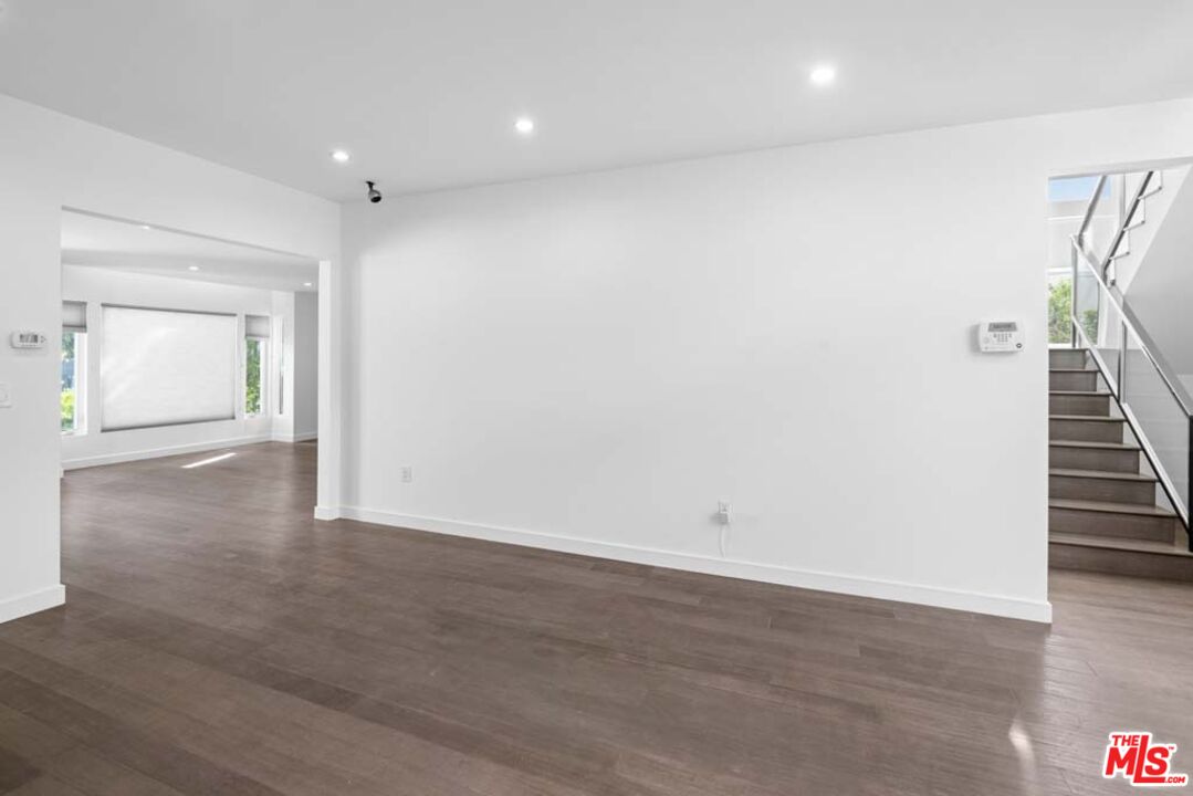 10453 Holman Avenue Los Angeles, CA 90024 - Photo 18 of 67 an empty room with wooden floor and stairs