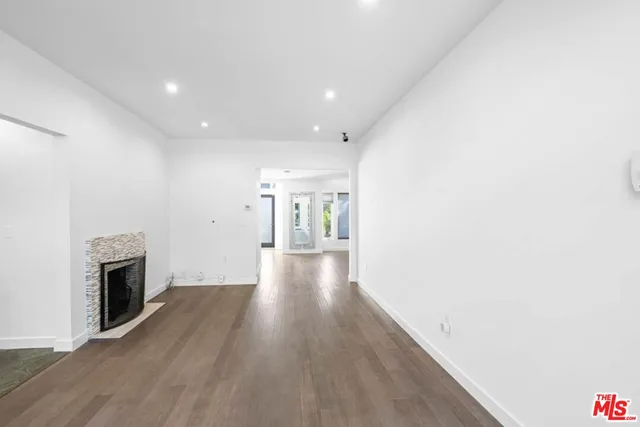 a view of a hallway with wooden floor and entryway