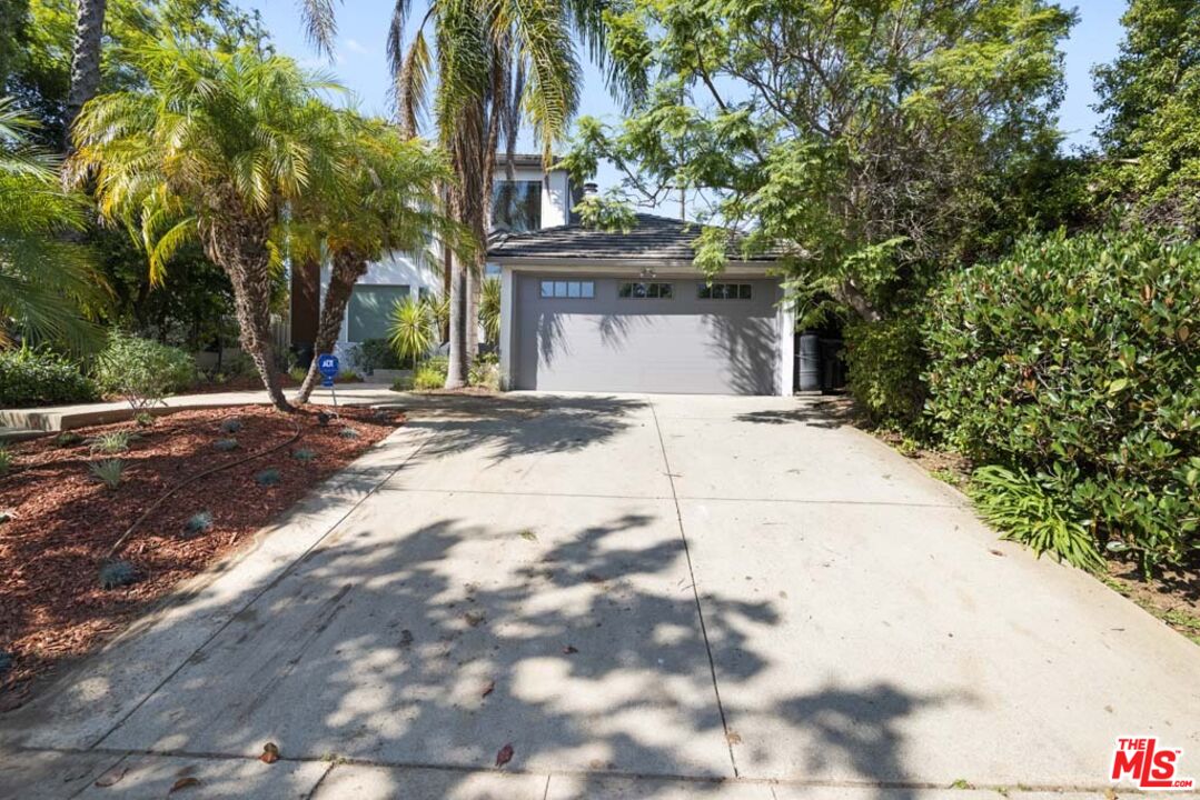 10453 Holman Avenue Los Angeles, CA 90024 - Photo 2 of 67 a view of a house with a yard and garage