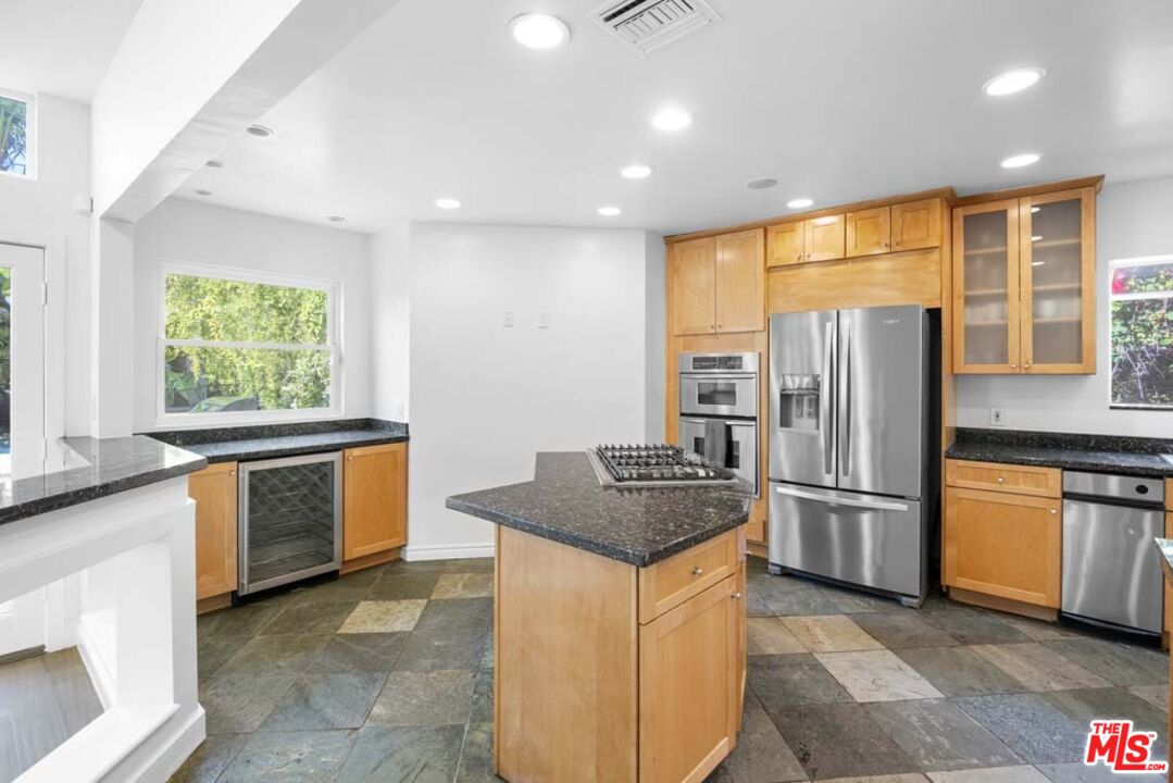 10453 Holman Avenue Los Angeles, CA 90024 - Photo 21 of 67 a kitchen with stainless steel appliances granite countertop a refrigerator a sink a stove a washer dryer and a refrigerator